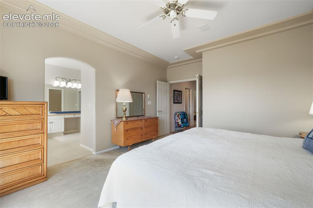 Image 20 of 50: Formal dining area featuring an arched entryway, tray ceiling with decorati