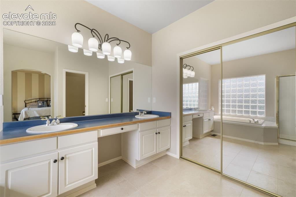 Image 21 of 50: Carpeted room featuring a large bay window, crown molding, and a ceiling fa