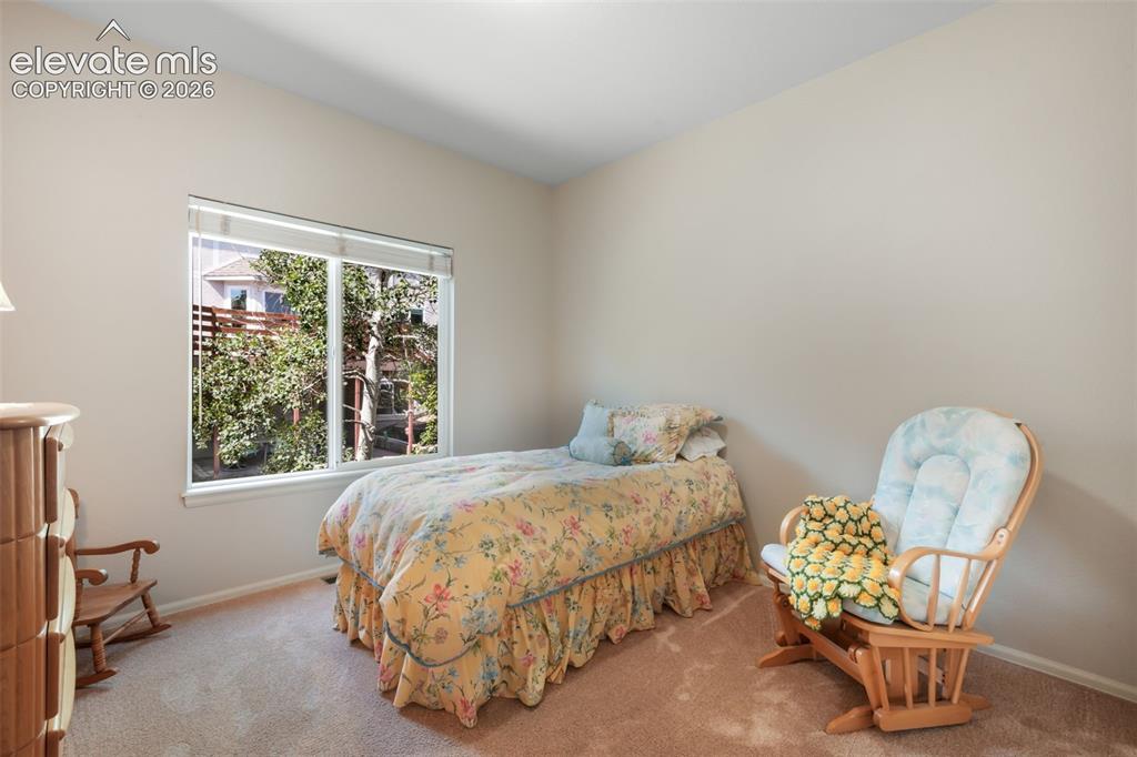 Image 23 of 50: Carpeted bedroom featuring neutral wall tones and a ceiling fan