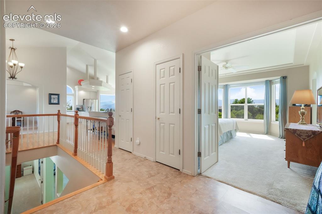 Image 28 of 50: Dedicated laundry area featuring white upper cabinetry with gold-tone hardw