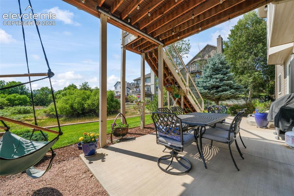 Image 45 of 50: Expansive elevated deck featuring composite decking and a wooden railing