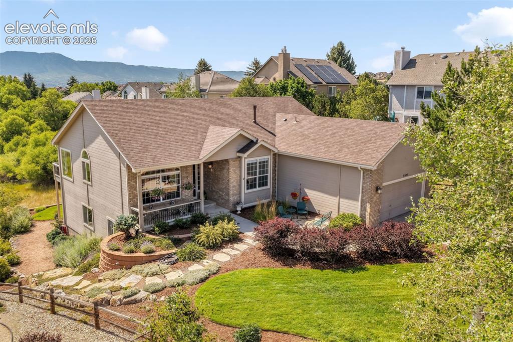 Image 49 of 50: Rear exterior featuring a multi-level deck, lower patio, and a landscaped y