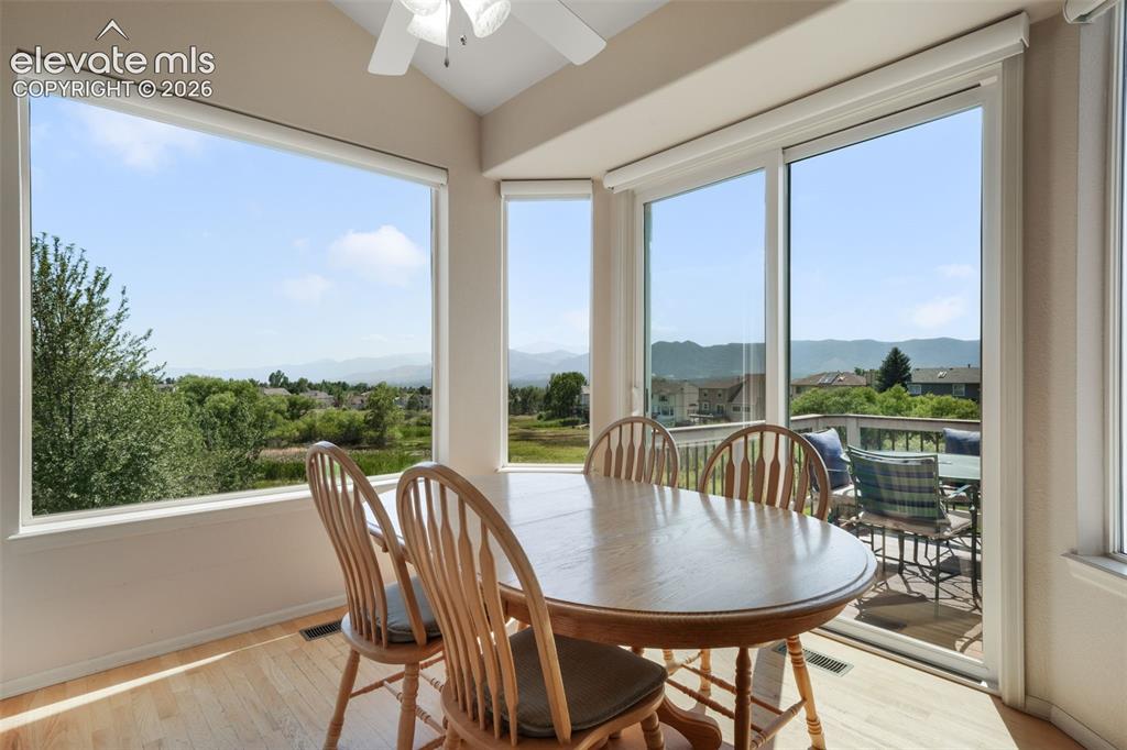 Image 7 of 50: Expansive outdoor deck featuring wood-finish flooring and a white railing w