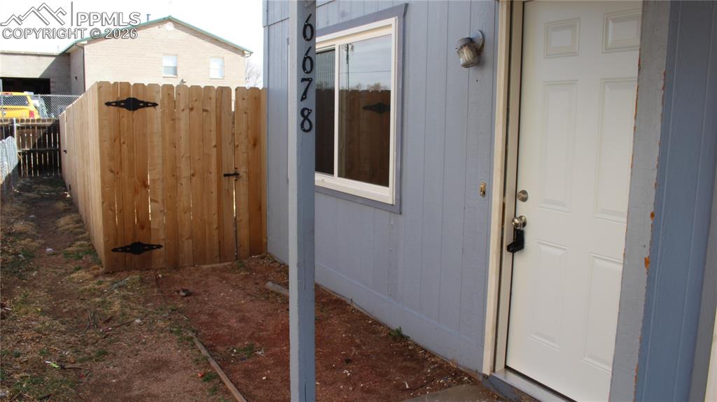 Image 1 of 12: Front door and fence to private backyard