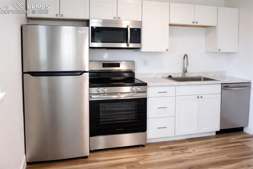 Image 4 of 12: Brand-new appliances, cabinets, and countertop
