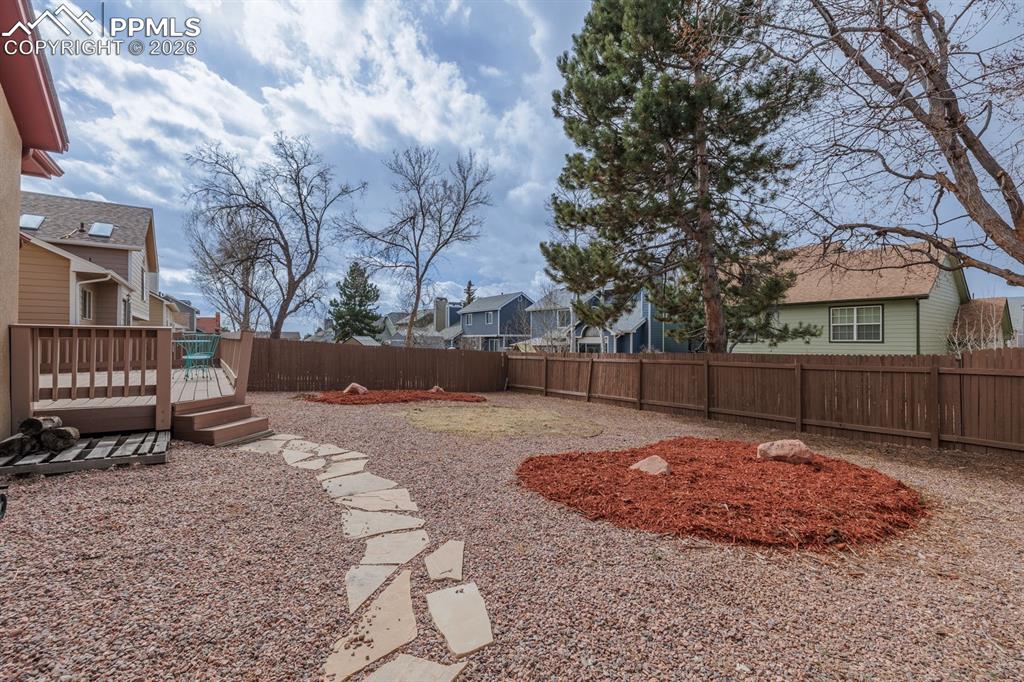 Image 13 of 40: Walk down to yard off of deck