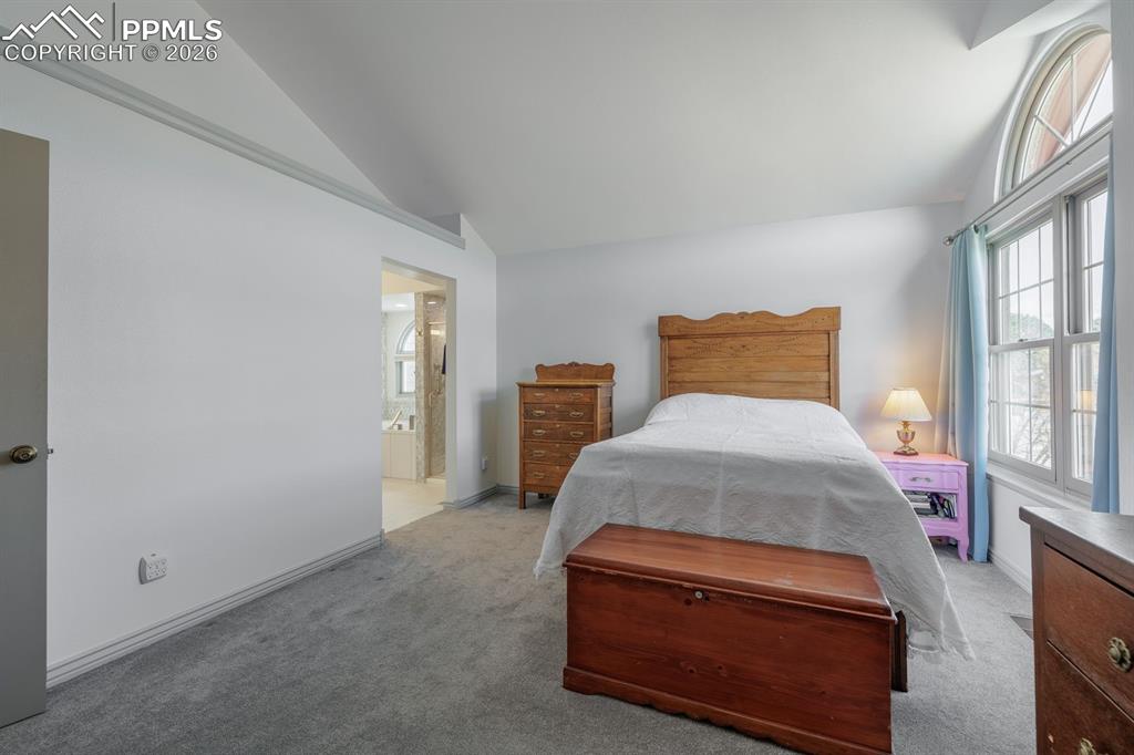 Image 19 of 40: Primary bedroom to spa like bathroom