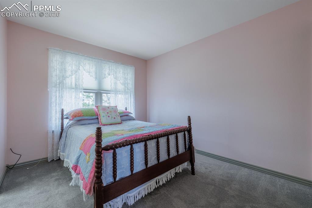 Image 21 of 40: One of two bedrooms on upper level at other end of hall