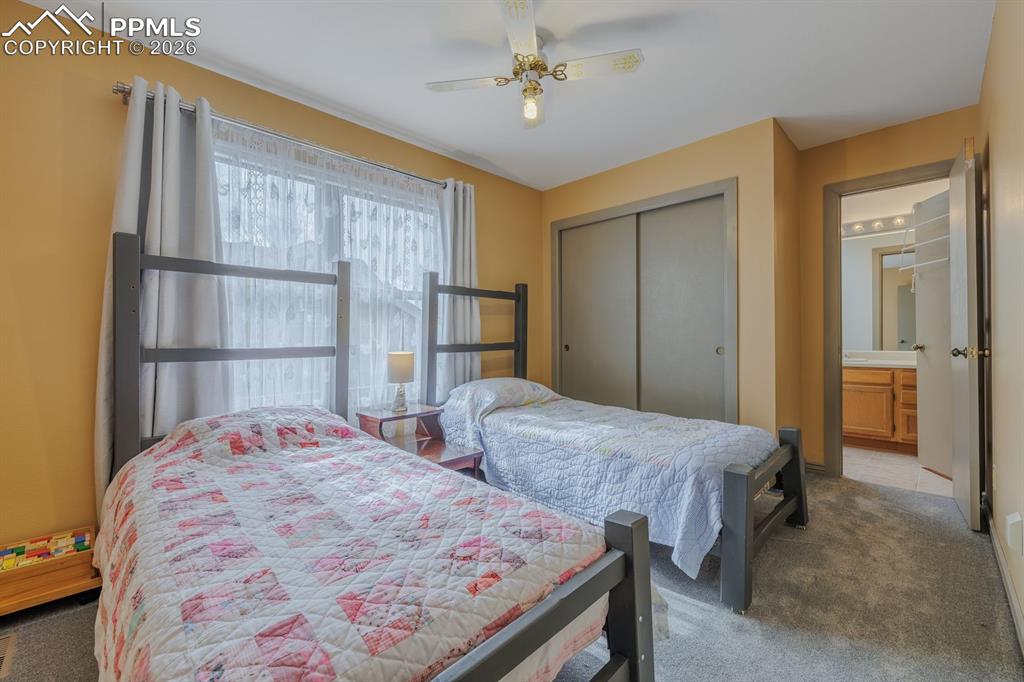 Image 23 of 40: Second bedroom on upper level. Jack and jill bath serves both bedrooms