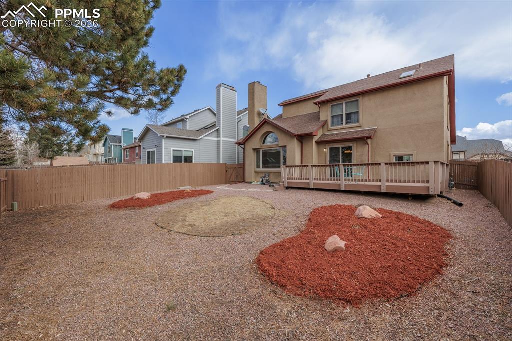 Image 27 of 40: Newly painted fence and great yard with grass area nad xeriscaping.Drip and