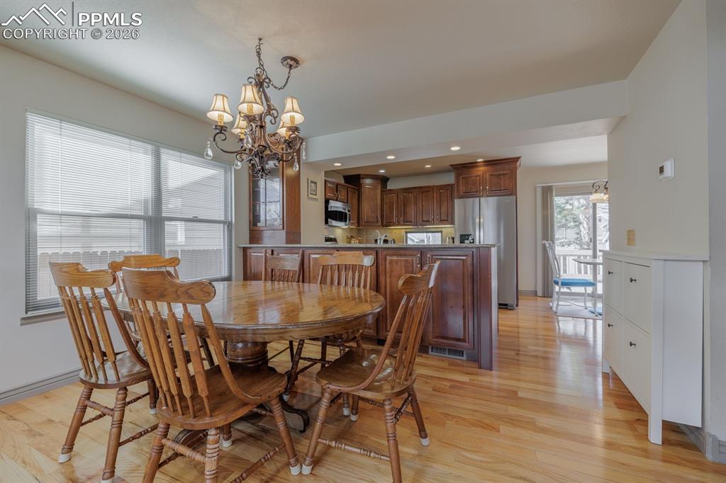 Image 7 of 40: Dining area with built in custom cabinetry under counter bar and custom bui