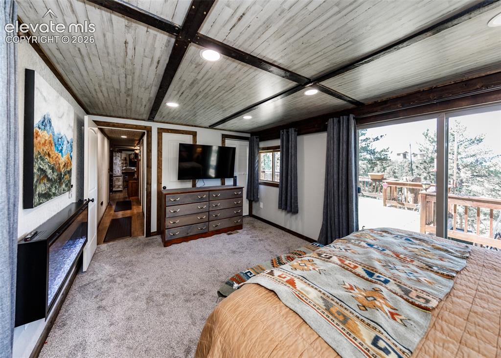 Image 30 of 50: Master bedroom with walk-out to back deck