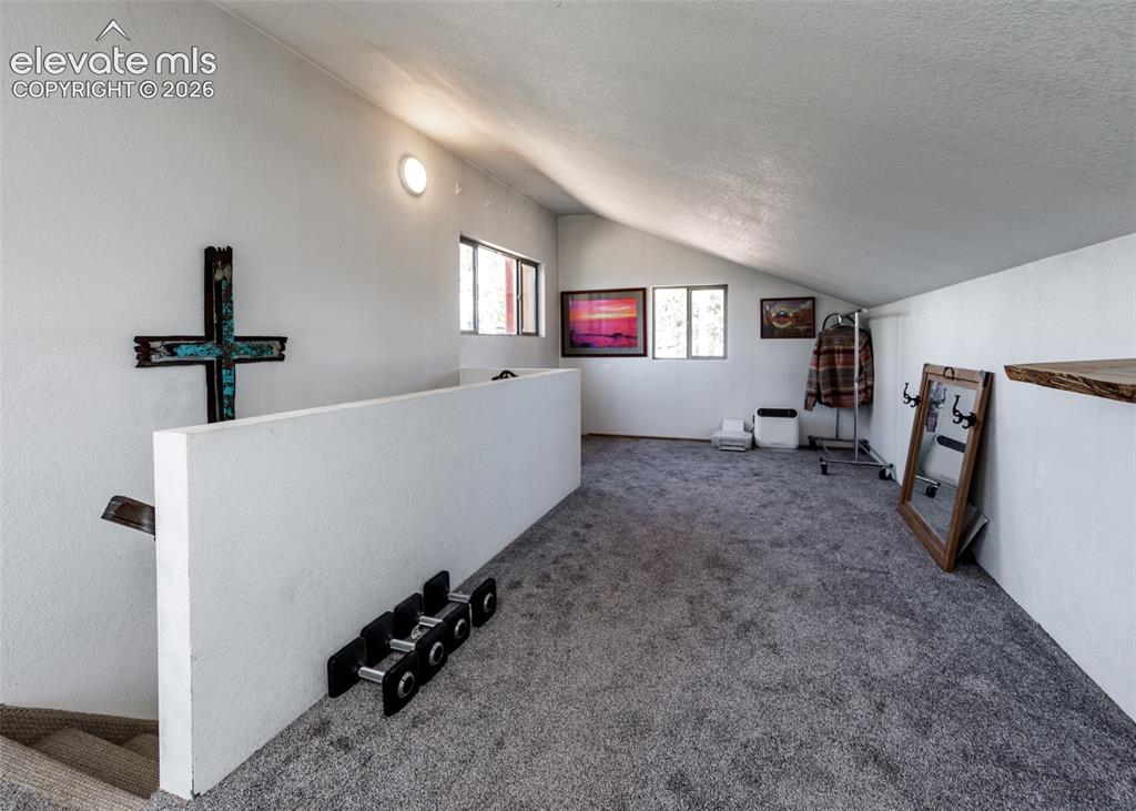 Image 34 of 50: Upper level loft/sitting room/workout room