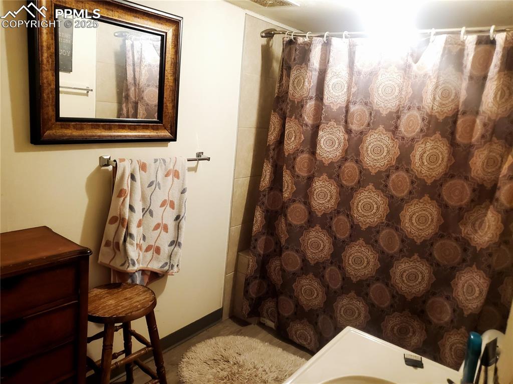 Image 17 of 22: Full bath with vanity