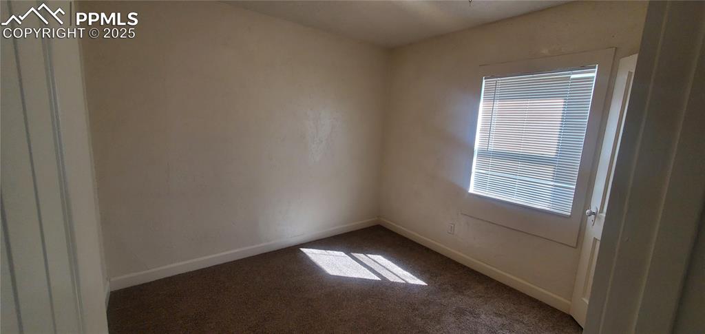 Image 9 of 22: Spare room featuring carpet and baseboards