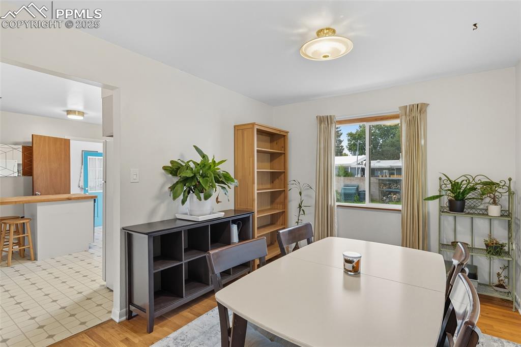 Image 10 of 39: Dining room with light wood-style flooring