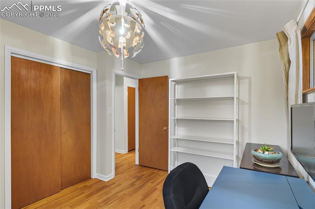 Image 17 of 39: Bedroom with light wood-type flooring and baseboards