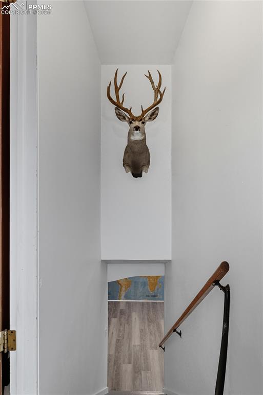 Image 21 of 39: Staircase with wood finished floors