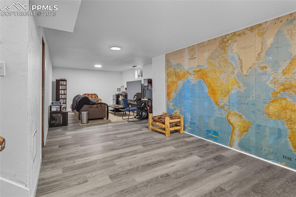 Image 22 of 39: Furnished basement laminate floors