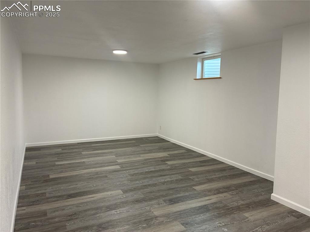 Image 25 of 39: Basement with gray laminate wood-style flooring with out furniture