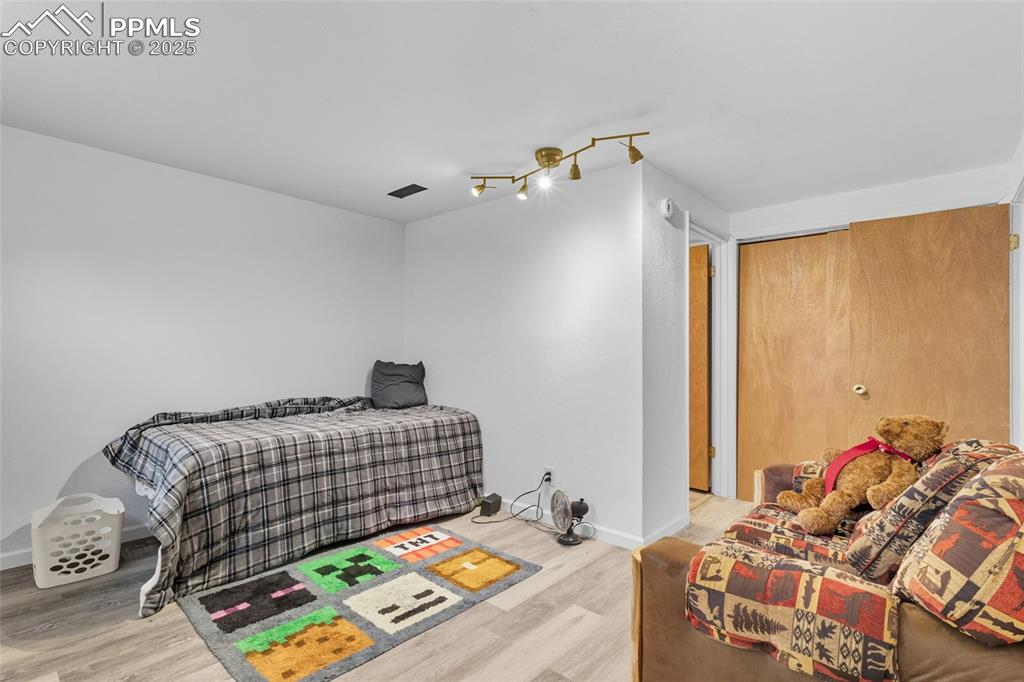 Image 28 of 39: Bedroom with light wood-style flooring and a closet