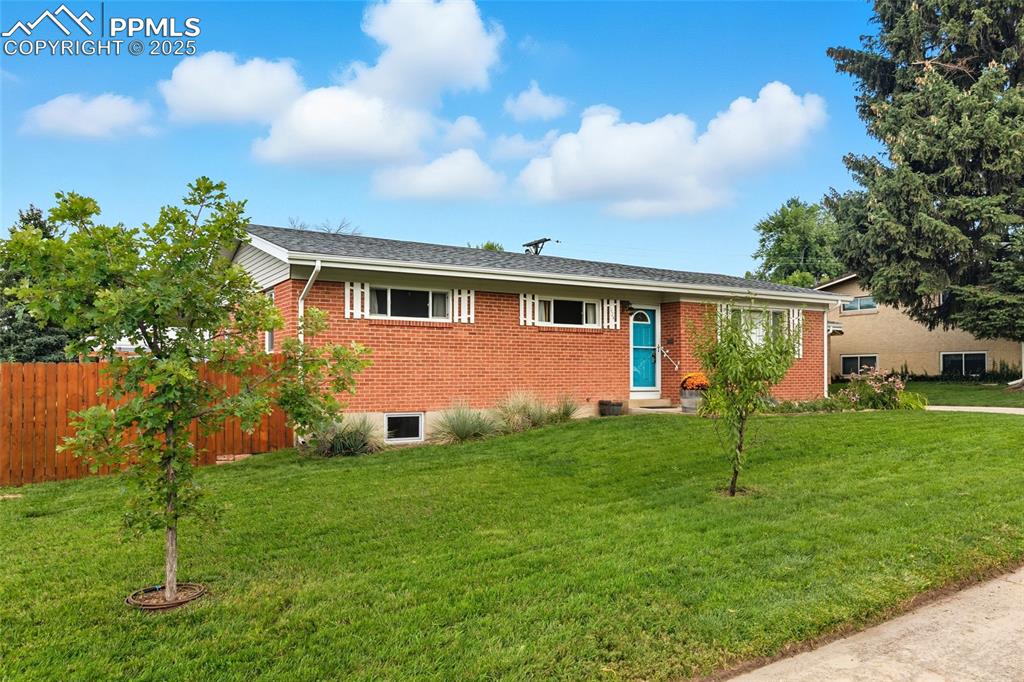 Image 3 of 39: Ranch-style house with brick siding