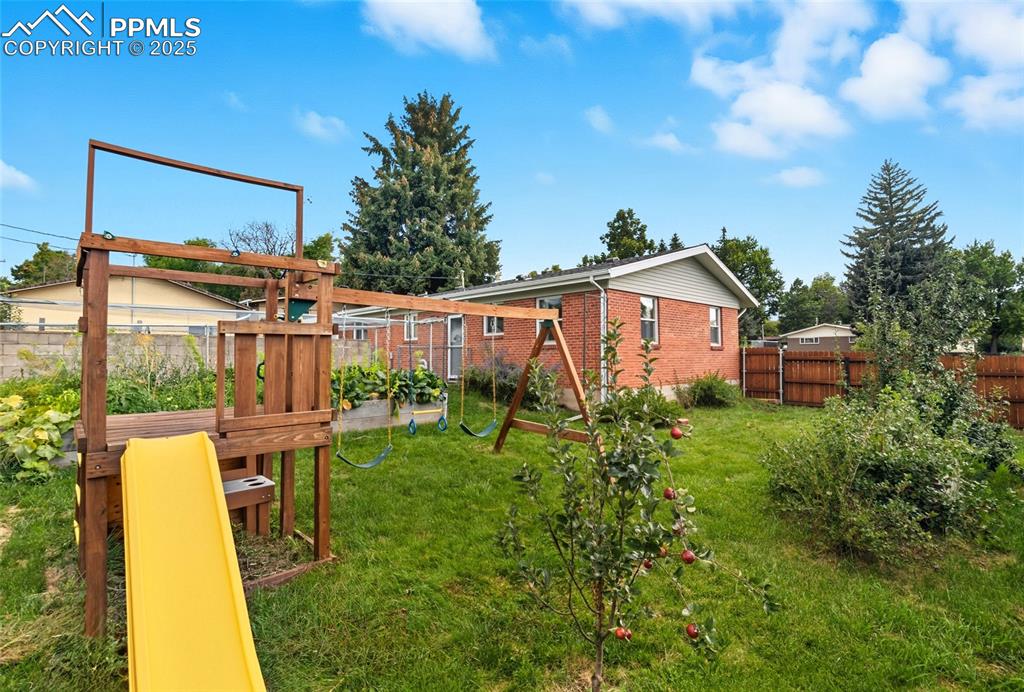 Image 36 of 39: View of jungle gym featuring a fenced backyard