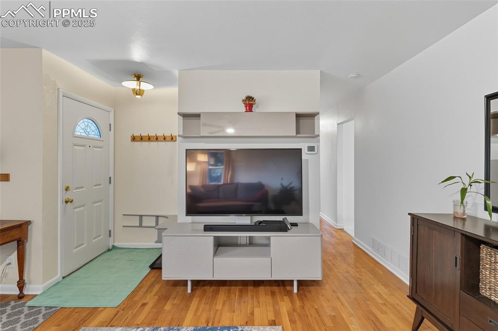 Image 8 of 39: Foyer entrance with light wood-style flooring