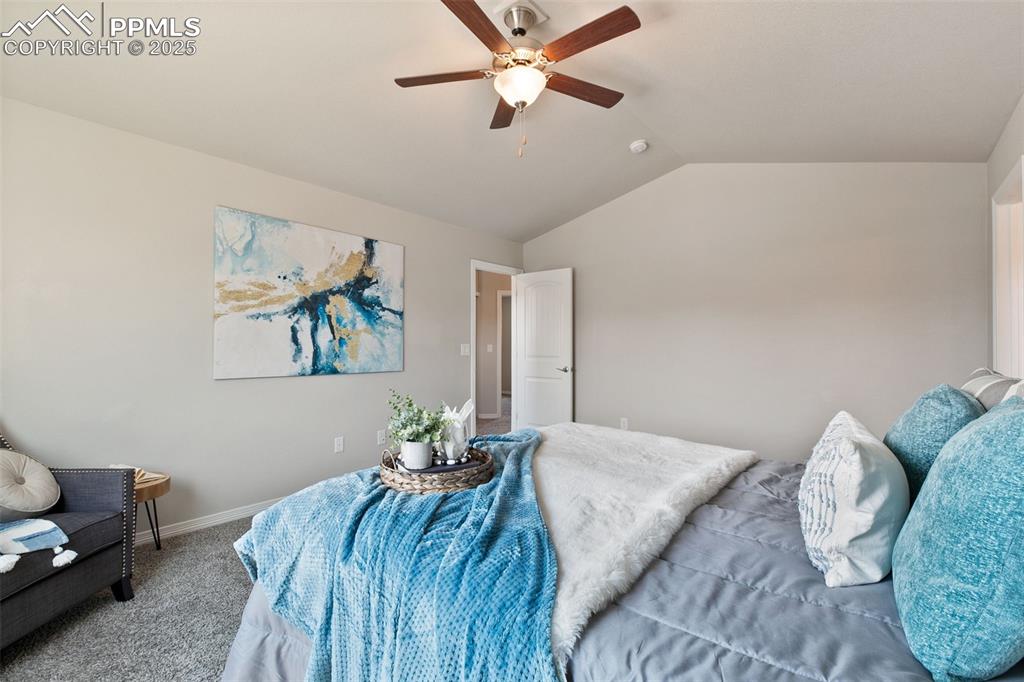 Image 16 of 28: Bedroom with lofted ceiling, carpet, and ceiling fan