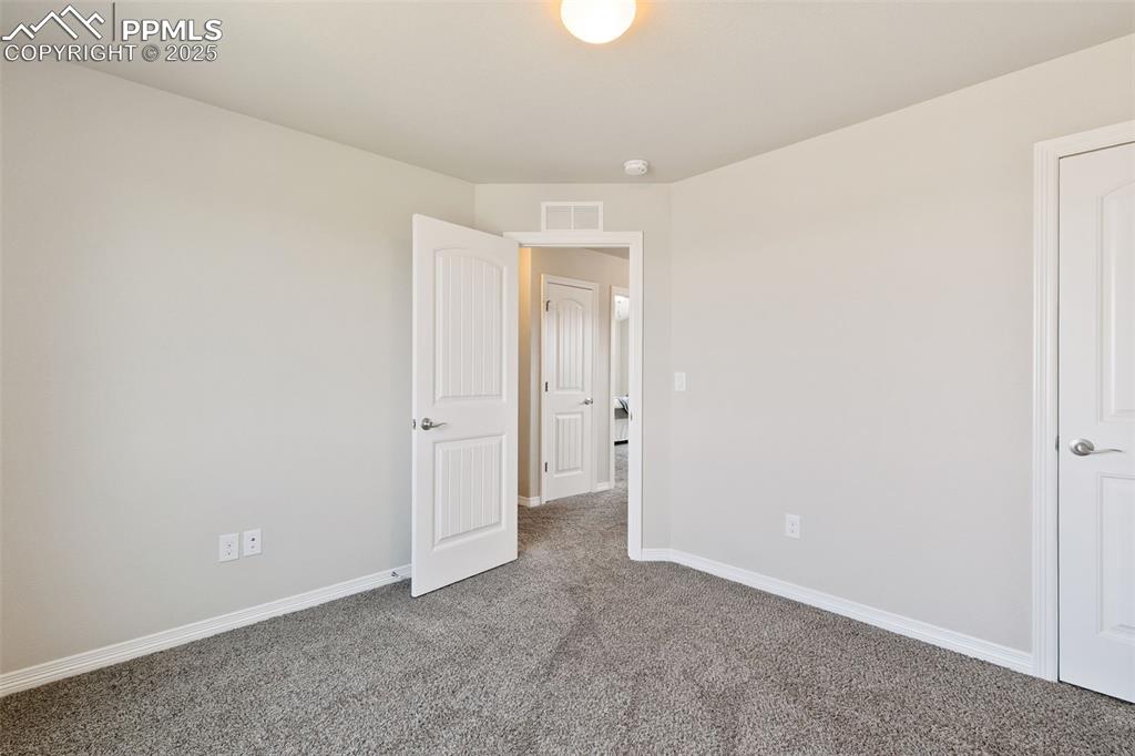 Image 20 of 28: Empty room featuring carpet flooring and baseboards