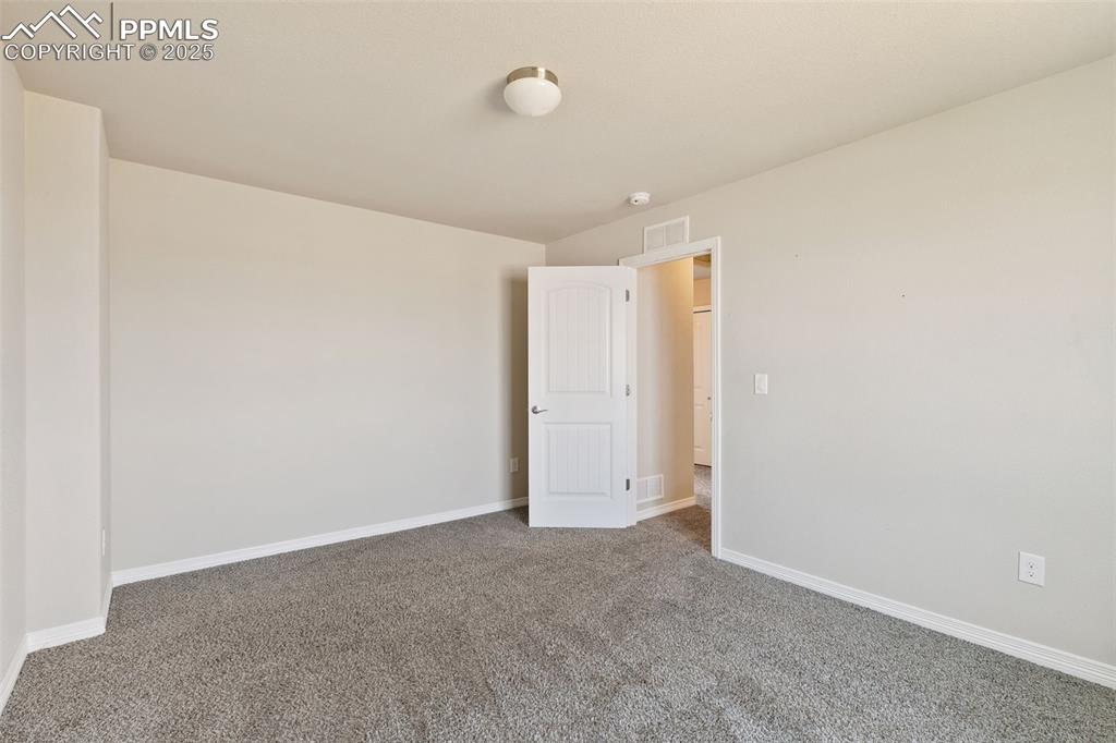 Image 22 of 28: Carpeted empty room featuring baseboards