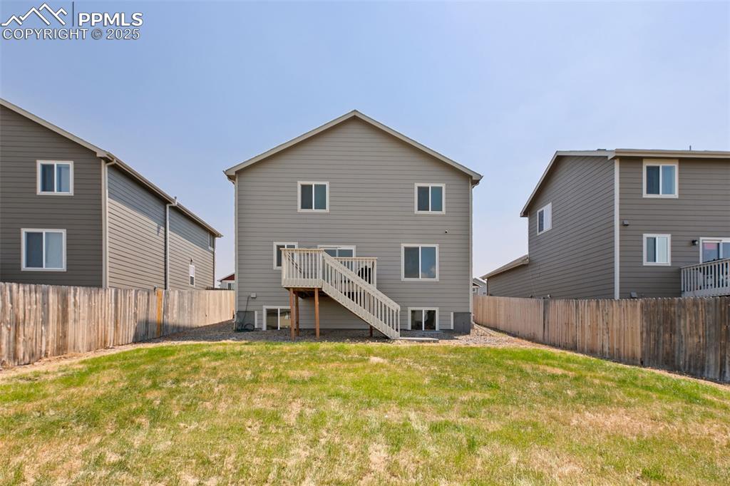 Image 28 of 28: Back of house with a wooden deck, stairs, and a fenced backyard