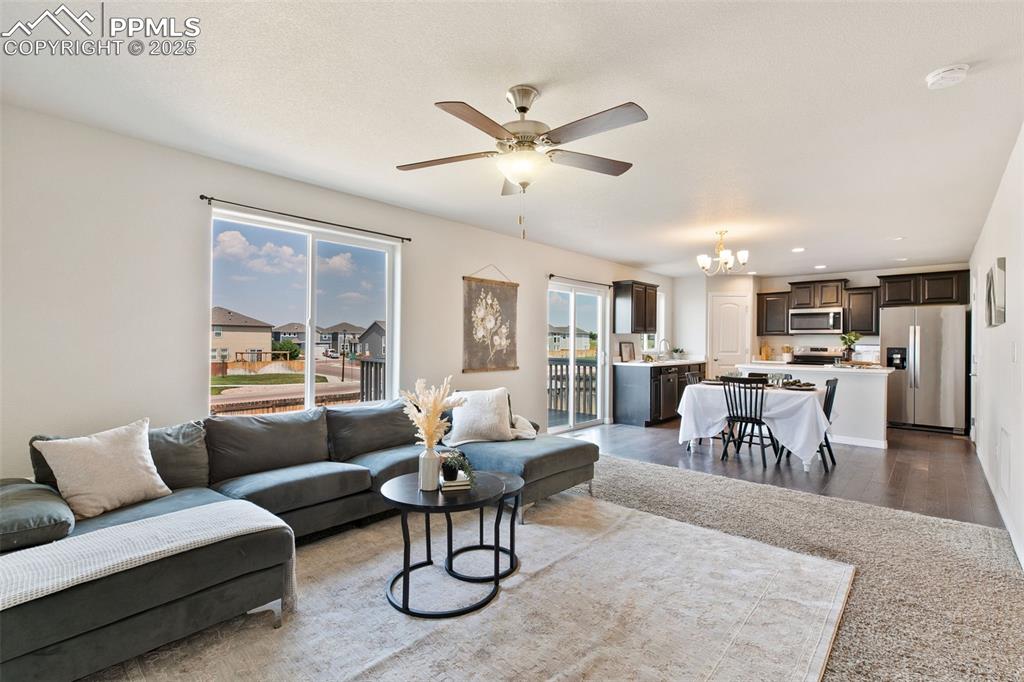 Image 7 of 28: Living area featuring healthy amount of natural light, a chandelier, a ceil