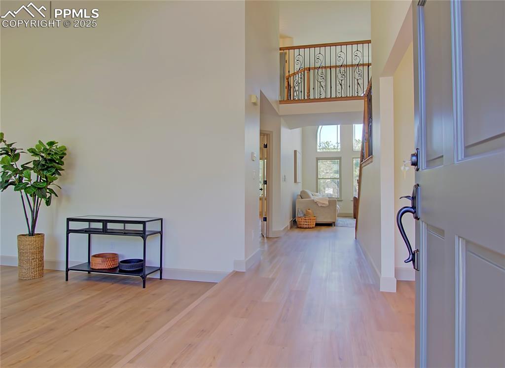 Image 4 of 50: Entrance foyer featuring light wood-style flooring and a high ceiling