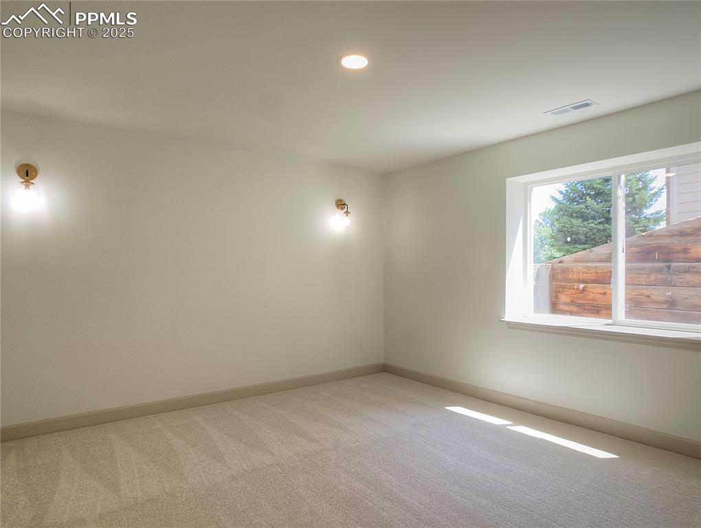 Image 45 of 50: Basement bedroom room featuring light carpet and recessed lighting