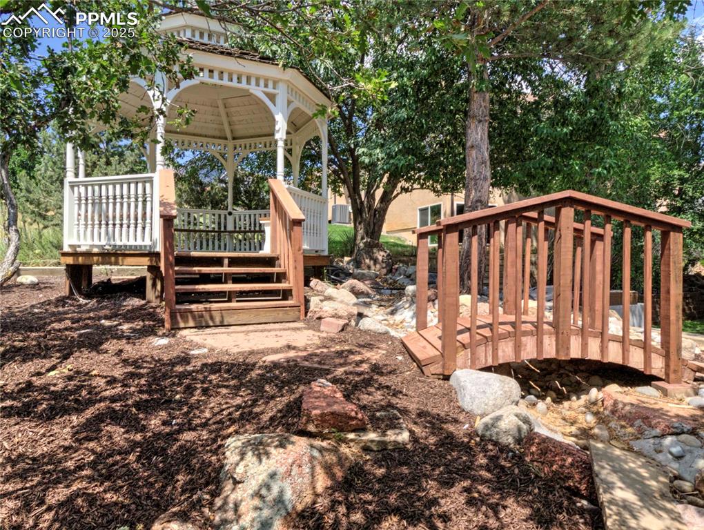 Image 49 of 50: Wooden terrace featuring a gazebo