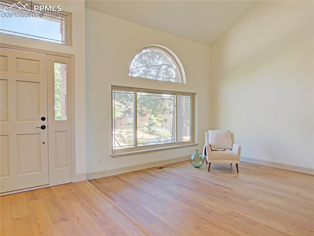 Image 5 of 50: Front Door and Living Room