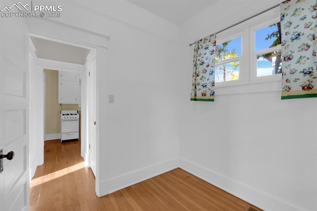 Image 11 of 28: Spare room with light wood-style flooring and baseboards