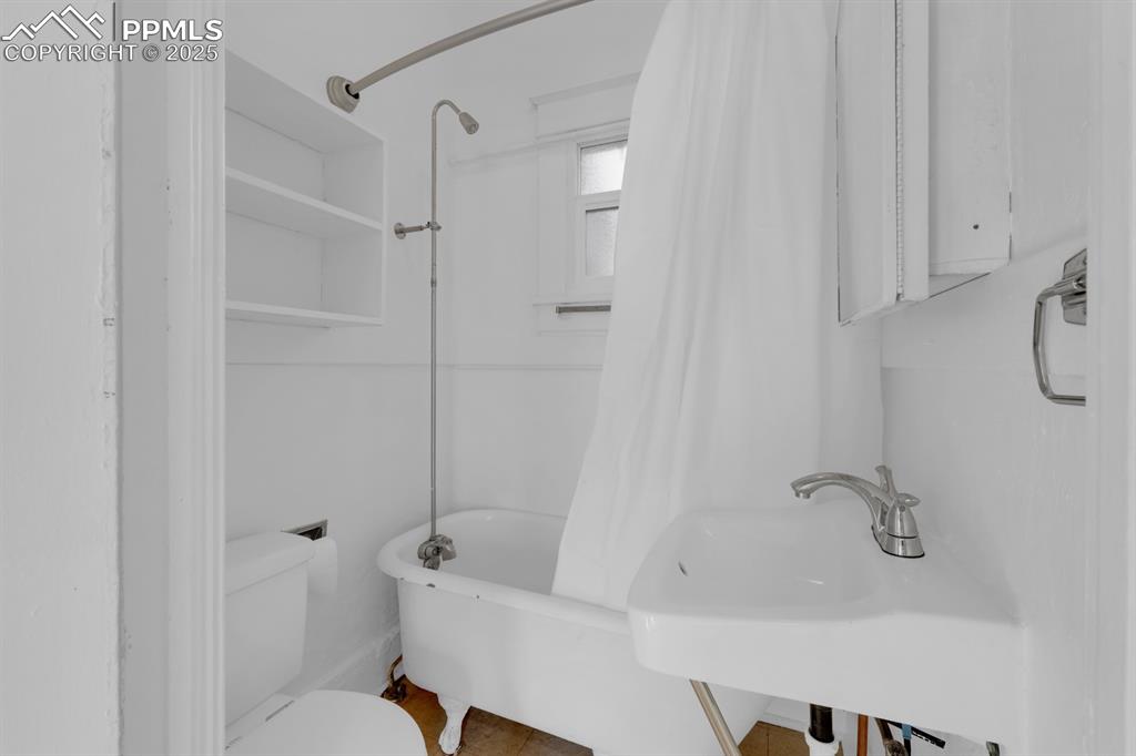 Image 13 of 28: Bathroom featuring shower / tub combo and toilet