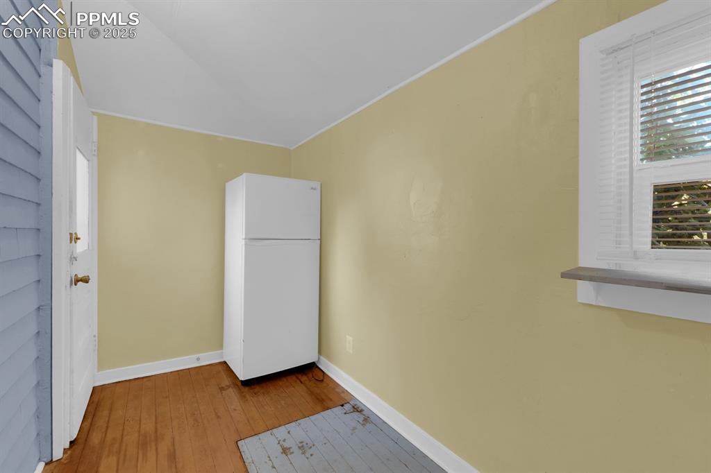 Image 16 of 28: Spare room with hardwood / wood-style floors and baseboards
