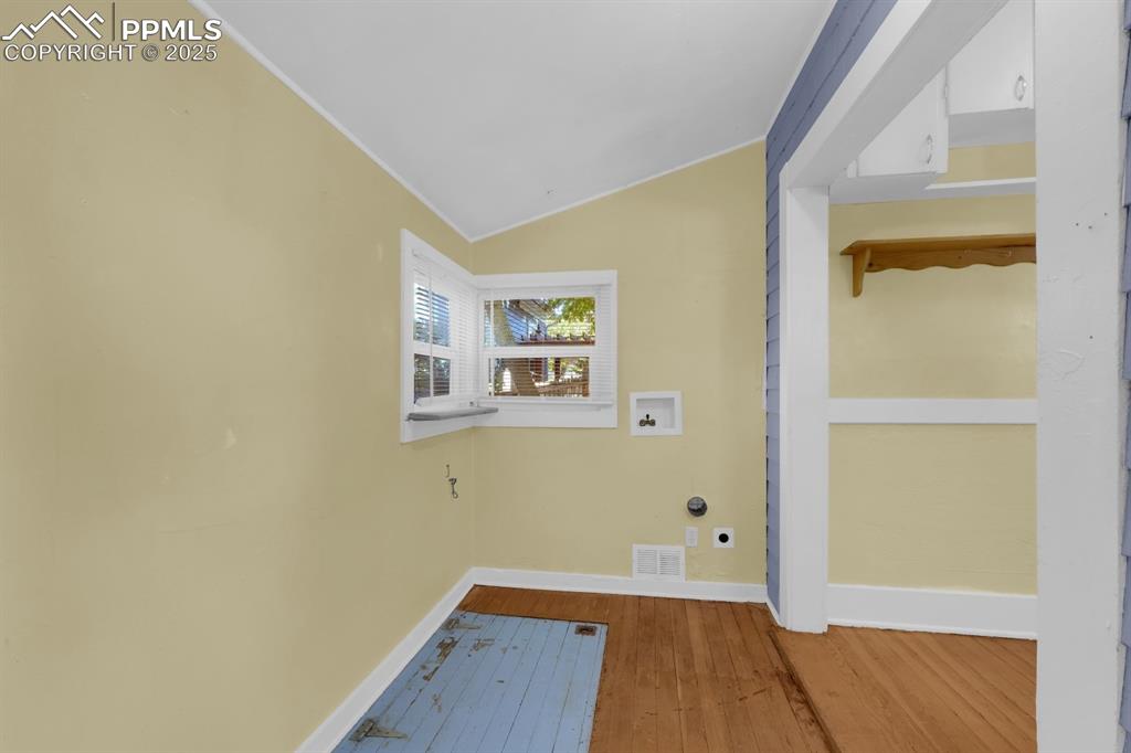 Image 18 of 28: Laundry room featuring wood-type flooring, hookup for a washing machine, va