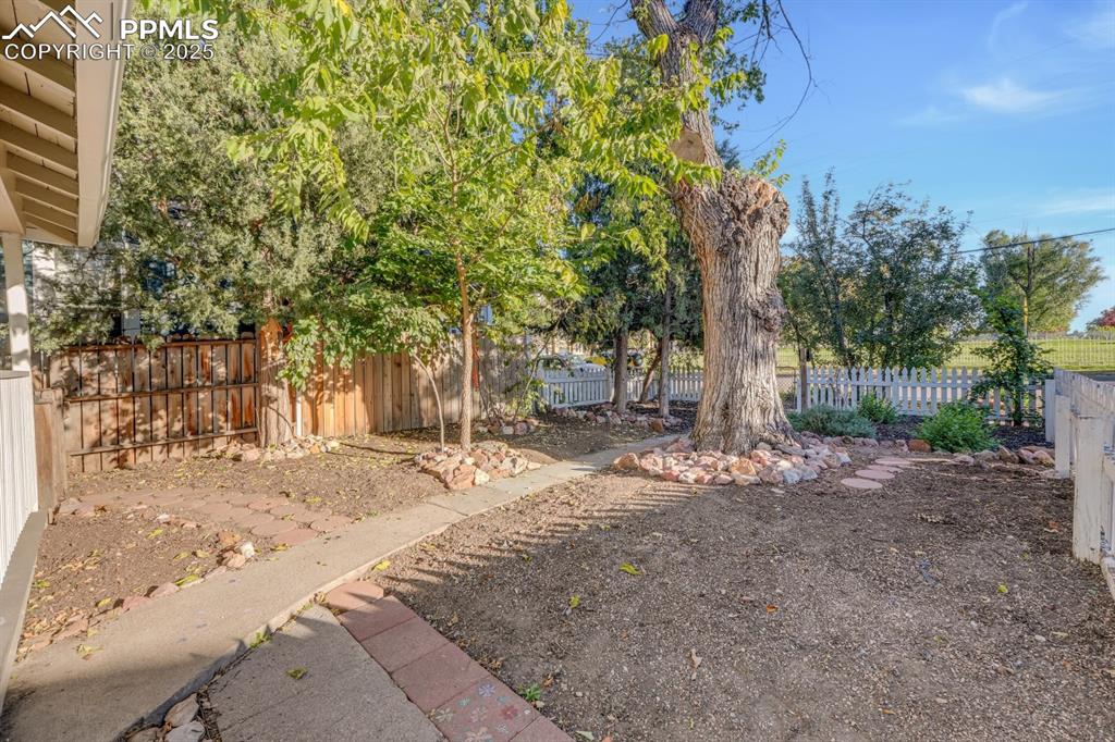 Image 26 of 28: View of fenced backyard