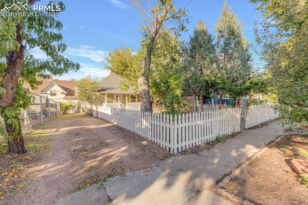 Image 5 of 28: View of front of home featuring a fenced front yard