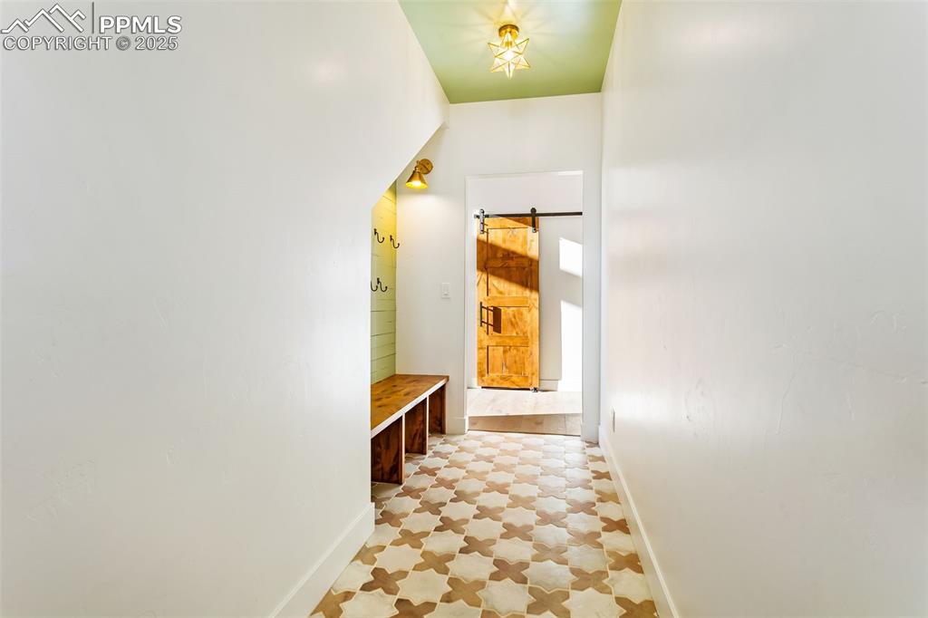 Image 38 of 49: Mudroom featuring baseboards