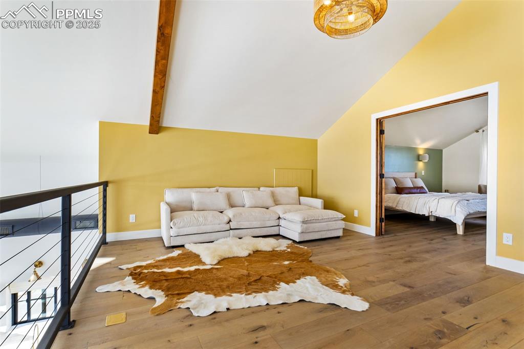 Image 44 of 49: Living room featuring hardwood / wood-style floors and baseboards