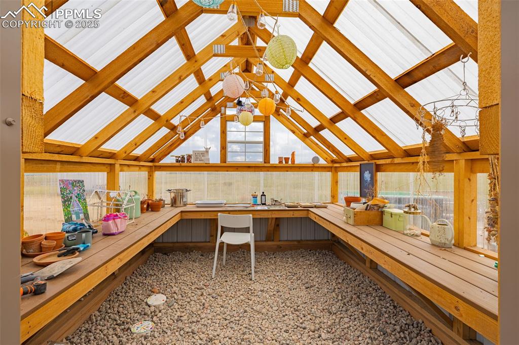 Image 46 of 49: Sunroom with lofted ceiling
