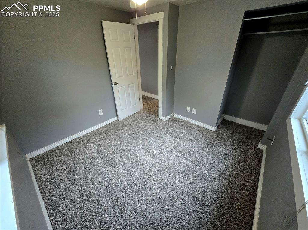 Image 12 of 22: Bedroom with carpet, a closet, and baseboards