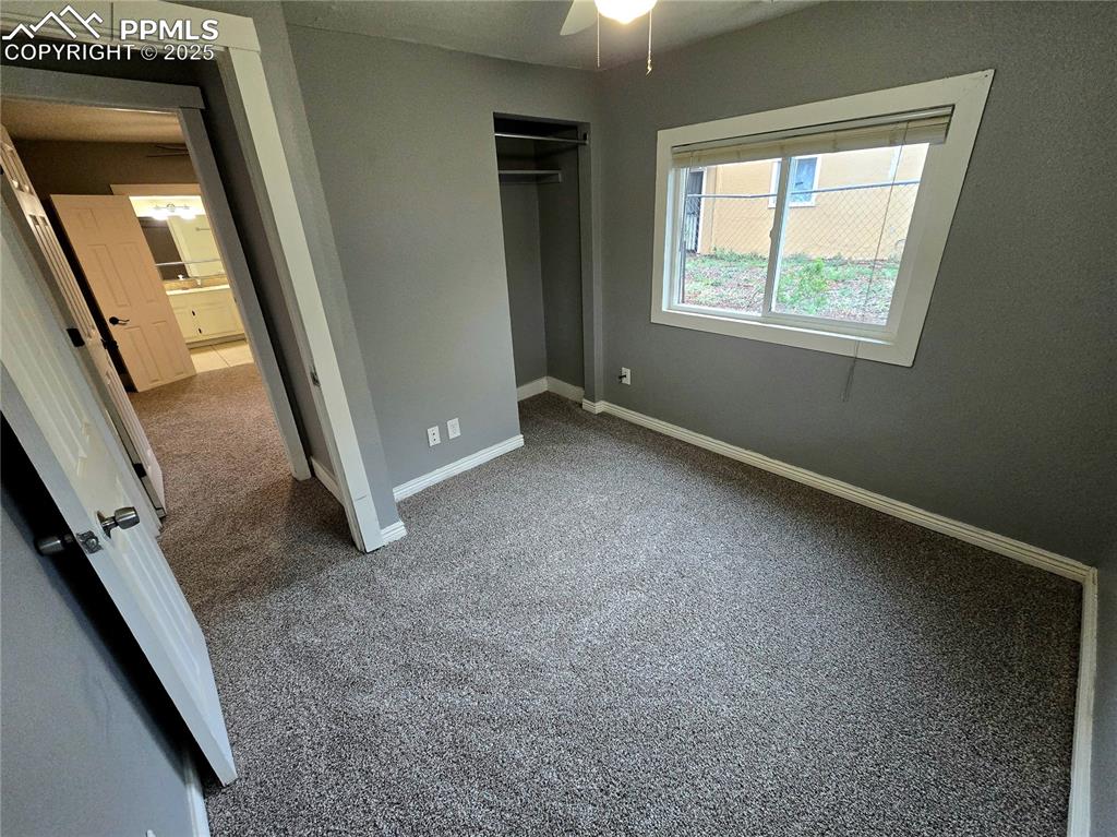 Image 13 of 22: Bedroom featuring carpet flooring, baseboards, a closet, and a ceiling fan