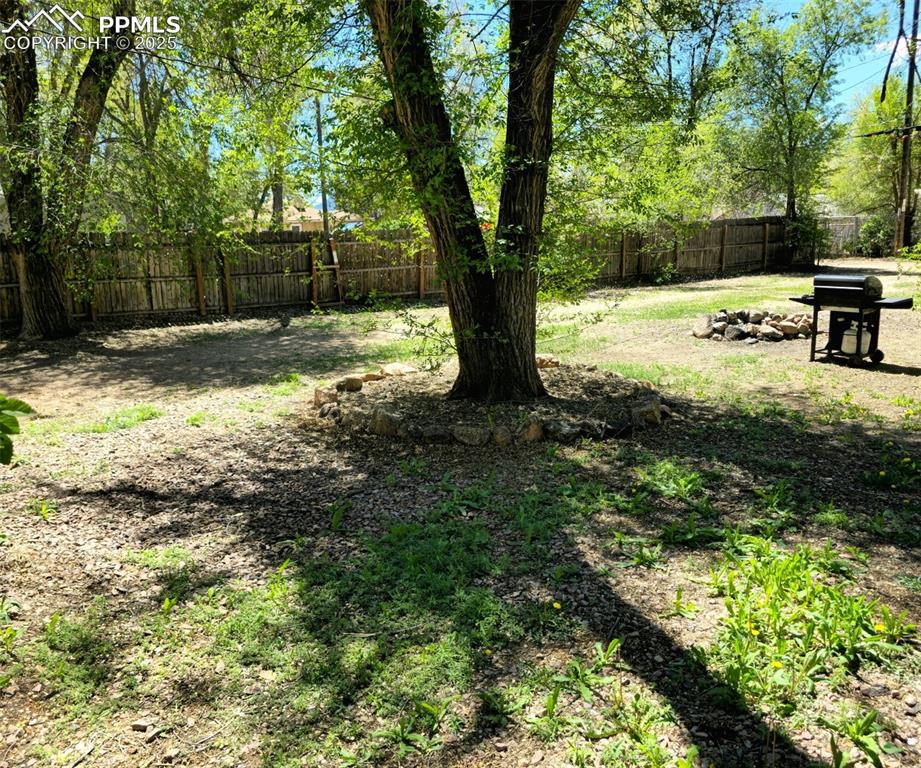 Image 17 of 22: View of partially fenced backyard
