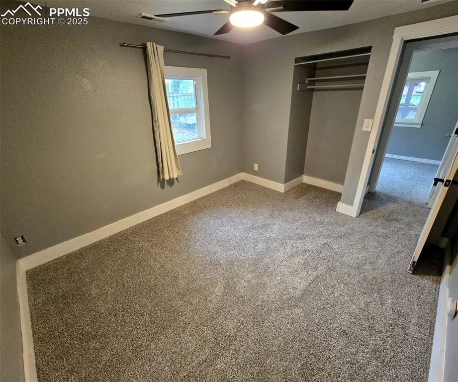 Image 6 of 22: Bedroom with multiple windows, a closet, and carpet floors